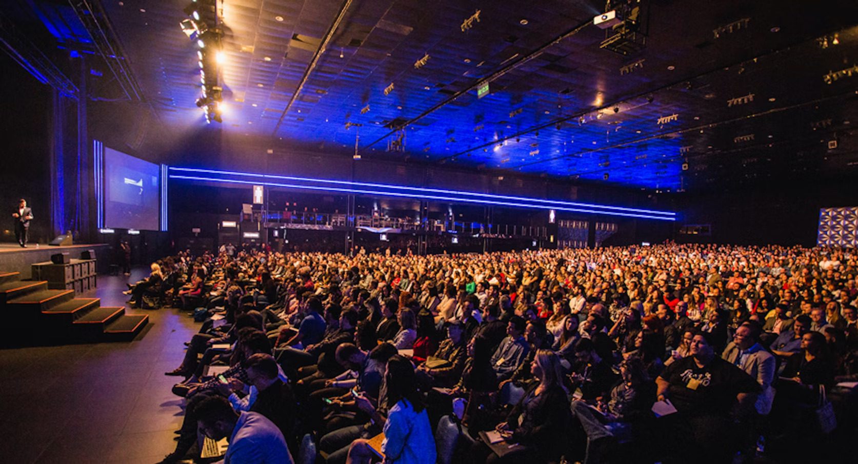 A large conference hall, with many spectators